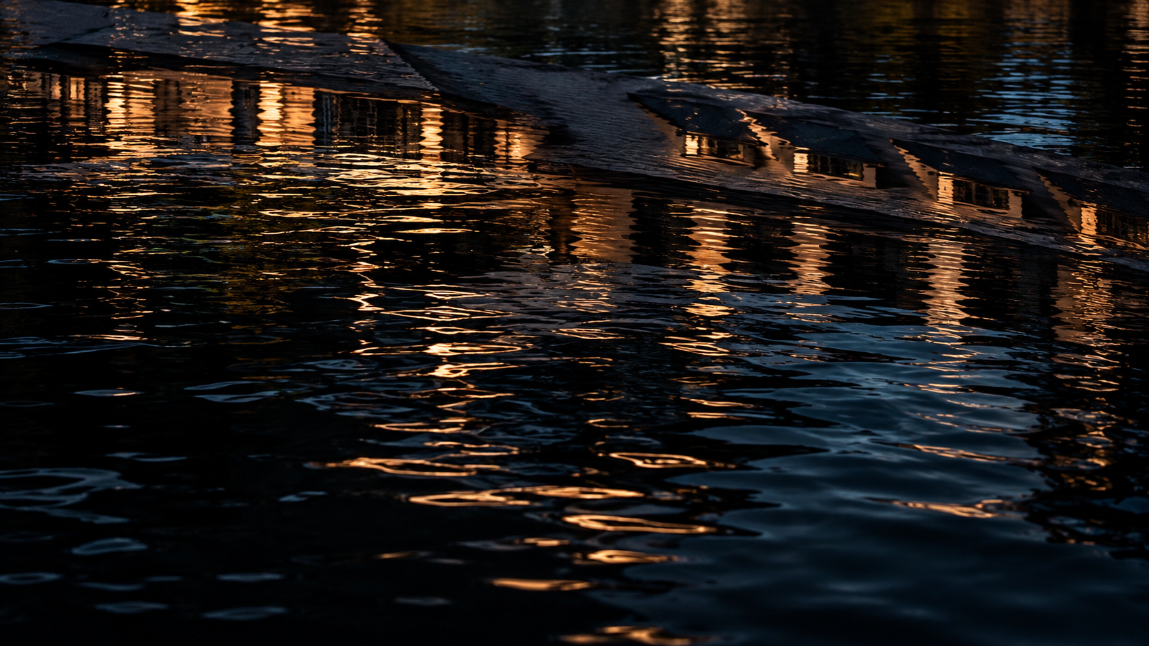 Architectural light reflected in dark water